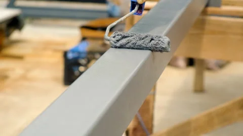 A man paints metal with a roller. Selective focus. Stock Footage 247267361