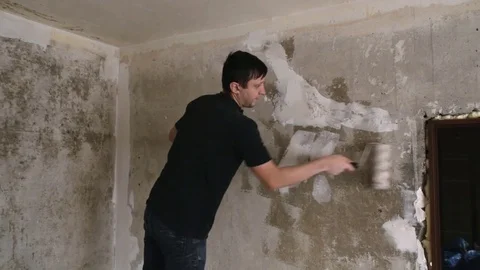 Man paints the plastered wall Stock Footage 83872838