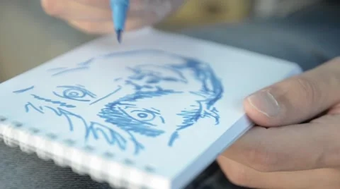 The man paints a portrait in a notebook. Stock Footage 51755270