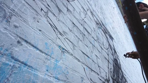 Man paints using airbrush on the wall Stock Footage 80931005