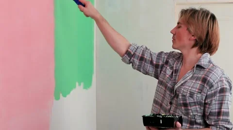 Man Paints The Wall In Green Paint Roller Stock Footage 51925238
