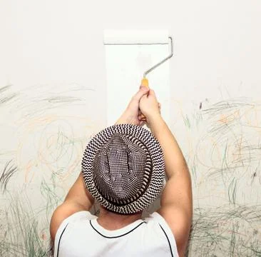 Man paints the wall Stock Photos