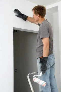 Man paints a wall Stock Photos