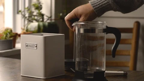 Man In Pajamas Adding Coffee Grinds To A French Press Stock Footage 117692506