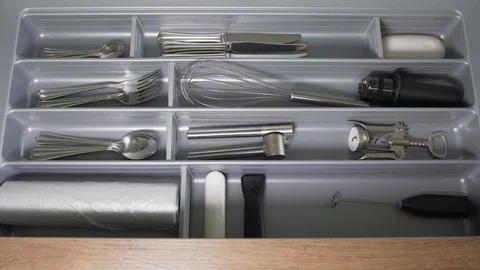 Man in pajamas opens a drawer with kitchen cutlery Stock Footage 121312835