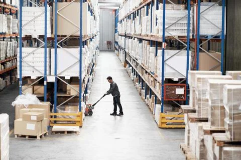 Man, pallet jack and boxes in warehouse for logistics, inventory management or Stock Photos