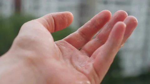Man palm catching rain drops. Staying at home concept. Rainy day, catching water 動画素材 133728812