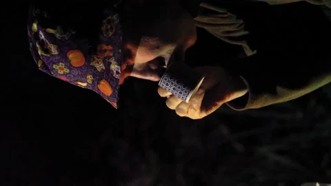 Man in panama hat drinking coffee near camp fire Stock Footage 207432268