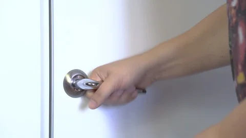 A man in a panic pulls the door handle, can not open the door. Stock Footage 117252456