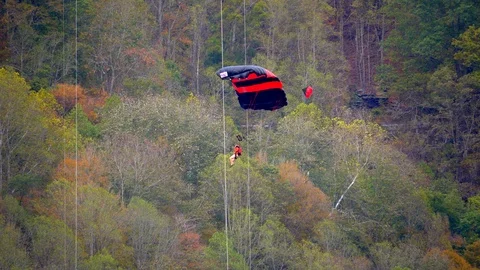 Man With Parachute in Forest, Base Jumping, Slow Motion Video stock 127469340