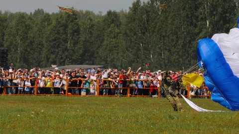 Man with a parachute is landing Video stock 260523209
