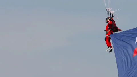 Man with a parachute is landing Stock Footage 264349659