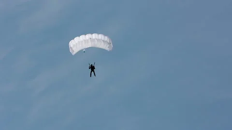 A man parachutes down to the ground. Parachute flight Vídeos de archivo 90312316