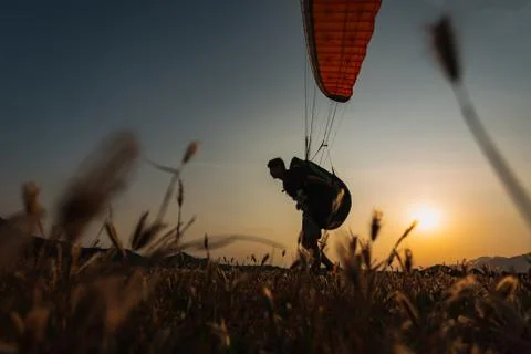 A man on a paraglider prepares to fly Stock Photos