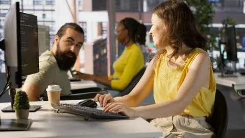 Man with paraplegia drinking coffee, checking progress done by employee Foto stock