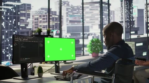 Man with paraplegia optimizing company software with mockup computer Stock Footage 318161581