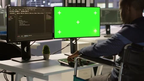 Man with paraplegia optimizing company software with mockup computer Stock Footage 318235367