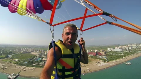Man Parasailing High in the Sky Stock Footage 40936237