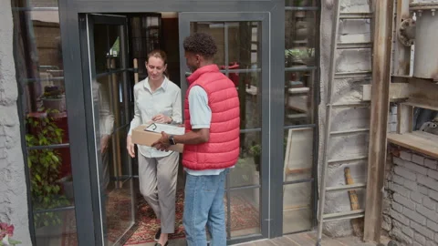 Man with Parcel Knocking On Door Stock Footage 316591124