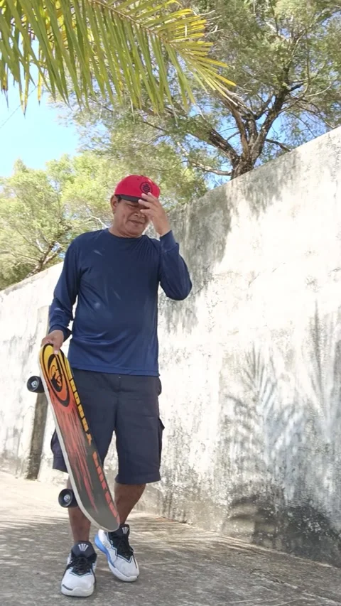 Man in a Park just on a Basic Training Skateboard on Sampaguita Boulevard Street Stock Footage 336658273