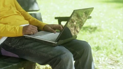 Man in a park using a laptop Stock-Footage 11340853