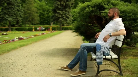 Man in the park waving to camera Stock Footage 64284427