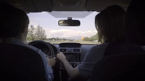 Man (In Passenger Seat) Adjusts Settings In Car, Touches Buttons, On A Road Trip Stock Footage 77970733