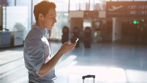 Man passenger using mobile smartphone in airport terminal Video stock 106000250