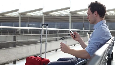 Man passenger using smart phone in airport Stock Footage 96127258