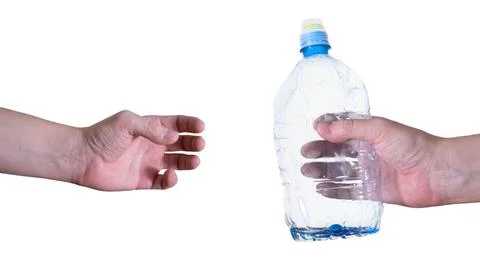 A man passes an empty, plastic bottle, isolated on a white background. Stock Photos