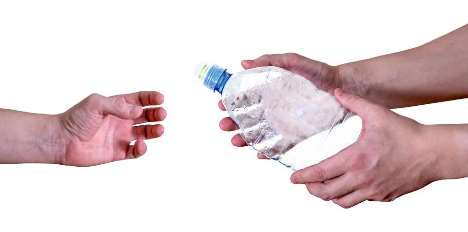 A man passes an empty, plastic bottle, isolated on a white background. Stock Photos