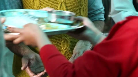 Man passing down plates in public kitchen in Amritsar, closeup. Stock Footage 50560458