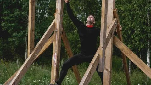 Man passing through hurdles during obstacle course in boot camp Stock Photos