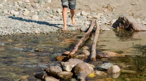 Man passing through the mountain river Stock Footage 48893545