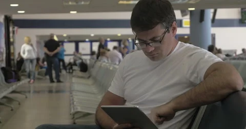 Man Passing Time before Departure with Tablet Stock Footage 52373125