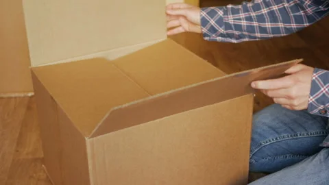 A man pastes a  QR code on a box. Delivery service. Online shop. Bar code. Stock Footage 105848095
