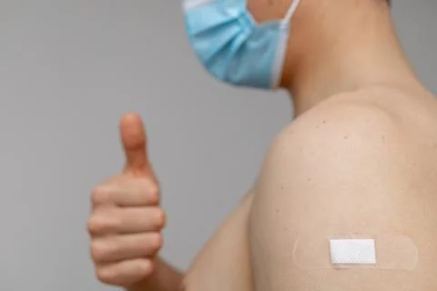 Man with patch on the shoulder showing thumbs up Stock Photos