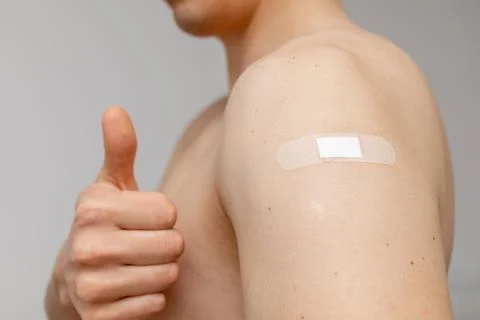 Man with patch on the shoulder showing thumbs up Stock Photos