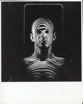 Man with patterns of light covering his face and shoulders in Air Force study in Stock Photos