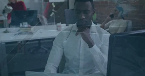Man pausing typing and adjusting headset, reviewing laptop for business with Stock Footage 331270103