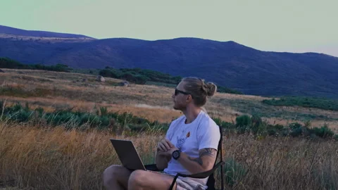 Man Pausing Work on Laptop to Look at Mountain Nature Vídeos de archivo 345717299