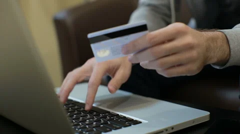 Man paying bill, shopping online, inserting credit card number. Stock Footage