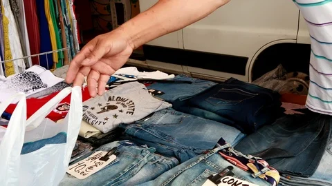 Man paying the clothes he has just bought. Stock Footage 112878302