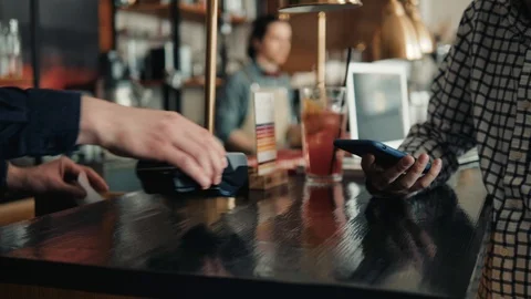Man paying with NFC technology on mobile phone in shopping mall, point of view Stock Footage 89971940