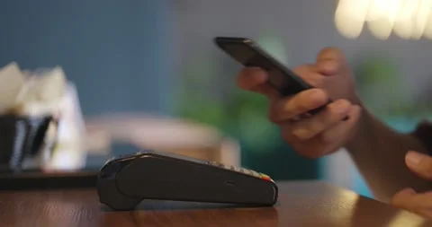 Man paying with NFC technology with smart phone credit card application Stock Footage 163931912