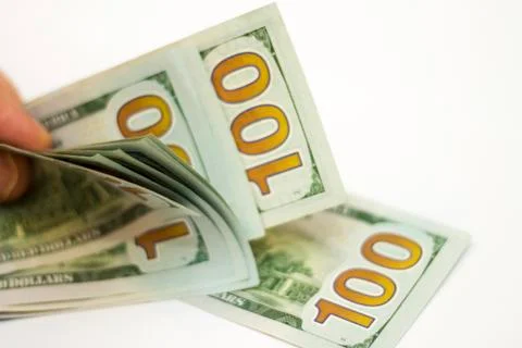 Man paying by Stack Of Paper Dollars Usa On The White Background Stock Photos
