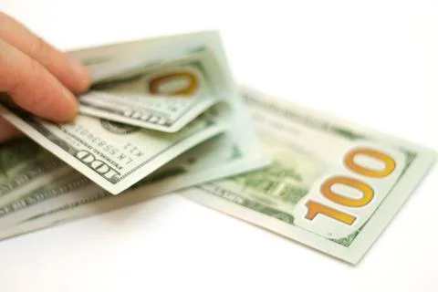 Man paying by Stack Of Paper Dollars Usa On The White Background Stock Photos