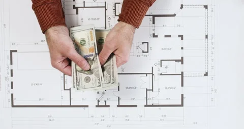 Man pays for builders work over building floor plan Stock Footage 277791549