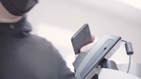 Man pays for purchases using a smartphone at the POS terminal Video stock 156854923
