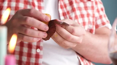 Man peeling and eating Easter cake on dinner table Stock Footage 303634773